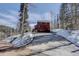 Long driveway leading to a beautiful mountain home surrounded by mature trees at 10438 Sunlight Ln, Conifer, CO 80433