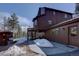 Charming home exterior featuring wood siding, multiple windows, and access to deck and natural surroundings at 10438 Sunlight Ln, Conifer, CO 80433