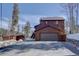 A view of the home's exterior, garage, shed, and driveway at 10438 Sunlight Ln, Conifer, CO 80433