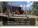 Charming exterior view of home with deck and stairs surrounded by forest and hosting an open house at 10438 Sunlight Ln, Conifer, CO 80433