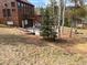 Cabin exterior featuring a spacious deck, patio area with seating, and beautiful landscaping at 10438 Sunlight Ln, Conifer, CO 80433