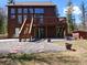 Multi-level house with decks surrounded by beautiful landscaping at 10438 Sunlight Ln, Conifer, CO 80433