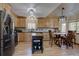 Well-lit kitchen featuring stainless steel appliances, wood cabinets, and a dining table at 10438 Sunlight Ln, Conifer, CO 80433
