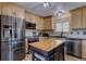 Updated kitchen boasts stainless steel appliances, light wood cabinets, and center island at 10438 Sunlight Ln, Conifer, CO 80433