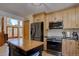 Bright kitchen area showcasing stainless steel appliances and offering access to an outdoor living space at 10438 Sunlight Ln, Conifer, CO 80433