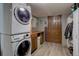 Laundry room with stacked washer and dryer, cabinets, countertop space, and storage at 10438 Sunlight Ln, Conifer, CO 80433