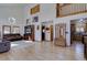 Open living room with hardwood floors, high ceilings, and a glimpse into the kitchen, creating a welcoming space at 10438 Sunlight Ln, Conifer, CO 80433