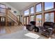 Inviting living room with hardwood floors and large windows offering scenic views at 10438 Sunlight Ln, Conifer, CO 80433