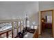 Living room with large windows, a high ceiling, a wood stove, and comfortable seating areas at 10438 Sunlight Ln, Conifer, CO 80433