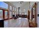 Bright living room with large windows, hardwood floors, vaulted ceilings, and a cozy fireplace, offering scenic views at 10438 Sunlight Ln, Conifer, CO 80433