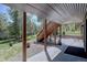 Covered outdoor space featuring wood columns and stairs at 10438 Sunlight Ln, Conifer, CO 80433