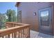 This home has a small front porch with wooden railings and exterior lighting at 10438 Sunlight Ln, Conifer, CO 80433