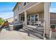Back porch with a hot tub, outdoor seating, and exterior view of the home at 16062 Red Bud Loop, Parker, CO 80134