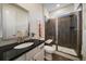 Modern bathroom with glass-enclosed shower, tiled walls, and a stylish vanity with granite countertop at 16062 Red Bud Loop, Parker, CO 80134