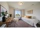 Cozy bedroom with desk, chair, modern decor, and bright natural light, perfect for relaxation or study at 16062 Red Bud Loop, Parker, CO 80134