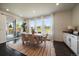 Bright dining area with natural light, sliding door access to a patio, and a modern light fixture at 16062 Red Bud Loop, Parker, CO 80134