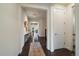 Inviting hallway features wood flooring, neutral walls, and stylish decor leading into open living spaces at 16062 Red Bud Loop, Parker, CO 80134