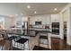 Modern kitchen featuring stainless steel appliances, a central island with bar stools, and sleek cabinetry at 16062 Red Bud Loop, Parker, CO 80134