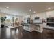 Open concept kitchen features a central island, modern appliances, and seamless flow to dining area at 16062 Red Bud Loop, Parker, CO 80134