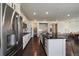 Gourmet kitchen features stainless appliances, white cabinets, granite countertops and dark hardwood floors at 16062 Red Bud Loop, Parker, CO 80134