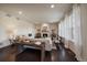 Bright living room with neutral palette offers large windows, wood floors, and a stone fireplace at 16062 Red Bud Loop, Parker, CO 80134