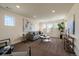 Spacious living room with plush sofa, large windows offering ample light, and stylish decor at 16062 Red Bud Loop, Parker, CO 80134