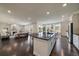 Open-concept living space featuring a kitchen island, a fireplace, and access to a patio at 16062 Red Bud Loop, Parker, CO 80134