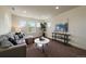 Bright living room with a comfortable couch, stylish decor, and three windows providing natural light at 16062 Red Bud Loop, Parker, CO 80134