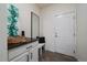Functional mud room with granite countertop, storage bench, mirror and closet at 16062 Red Bud Loop, Parker, CO 80134