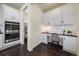 Office nook off kitchen with custom cabinets, white backsplash and stainless oven at 16062 Red Bud Loop, Parker, CO 80134