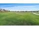 View of large open grassy area near homes in the neighborhood at 16062 Red Bud Loop, Parker, CO 80134