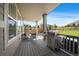 Covered outdoor patio with a built-in grill, seating, and views of the landscaped backyard at 16062 Red Bud Loop, Parker, CO 80134