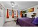 Bright bedroom with orange curtains, neutral carpet, featuring a ceiling fan and artwork at 6930 S Broadway, Centennial, CO 80122