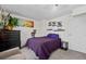 Cozy bedroom featuring a comfortable bed, a black dresser, stylish decor, and neutral carpeting at 6930 S Broadway, Centennial, CO 80122