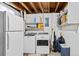 Well-equipped laundry room with a washer, dryer, refrigerator, and shelving for storage at 6930 S Broadway, Centennial, CO 80122