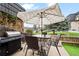 Outdoor patio with a gas grill, dining table, patio umbrella, and fenced yard at 6930 S Broadway, Centennial, CO 80122