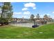 Fenced community pool surrounded by green grass and neighborhood buildings under a blue sky at 6930 S Broadway, Centennial, CO 80122