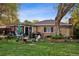 Charming backyard featuring a patio area with seating and a grill, ideal for outdoor entertaining and relaxation at 6390 W 47Th Ave, Wheat Ridge, CO 80033