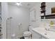 Cozy bathroom with white vanity, toilet, and storage shelves offers a clean and functional space at 6390 W 47Th Ave, Wheat Ridge, CO 80033