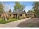 Charming brick home with a well-manicured lawn, landscaped front yard and long driveway at 6390 W 47Th Ave, Wheat Ridge, CO 80033