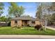 Charming brick home with a well-manicured lawn and landscaped front yard at 6390 W 47Th Ave, Wheat Ridge, CO 80033