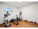 Home gym with a window and hardwood floors is ready for your workout at 6390 W 47Th Ave, Wheat Ridge, CO 80033
