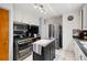 Spacious kitchen with stainless steel appliances and functional center island at 6390 W 47Th Ave, Wheat Ridge, CO 80033