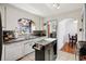 Well-lit kitchen with white cabinets, island, and view to breakfast nook at 6390 W 47Th Ave, Wheat Ridge, CO 80033