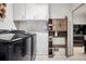 Organized laundry room with modern washer/dryer units and storage at 6390 W 47Th Ave, Wheat Ridge, CO 80033