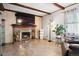 Inviting living room features a brick fireplace with a mounted television above and wood floors at 6390 W 47Th Ave, Wheat Ridge, CO 80033