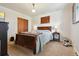 Cozy bedroom with a wooden sleigh bed, closet and bright natural light at 5118 S Osceola St, Littleton, CO 80123