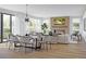Bright open-concept living and dining area with fireplace and large windows at 2778 Utica St, Denver, CO 80212