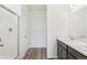 Bright bathroom showcasing a shower, toilet, and double sink vanity with dark wood cabinets at 9313 Biscay St, Commerce City, CO 80022