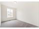 Bedroom features neutral walls and carpet and a view out of the large window at 9313 Biscay St, Commerce City, CO 80022